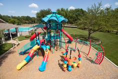 Blue Playground with Multi-color slide and climbing apparatus on sand in park